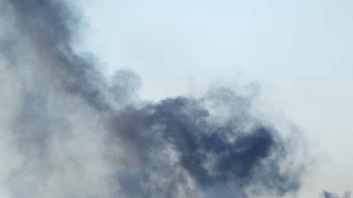 Black smoke rising in the sky