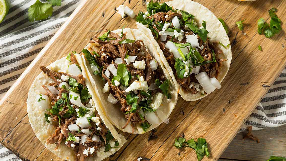Spicy Homemade Beef Barbacoa Tacos with Cilantro Cheese and Onion