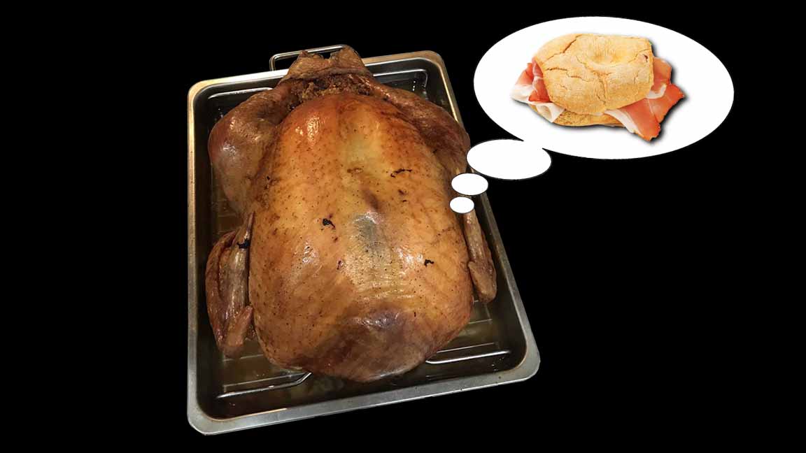 A roasted thurkey thinking about a sandwich