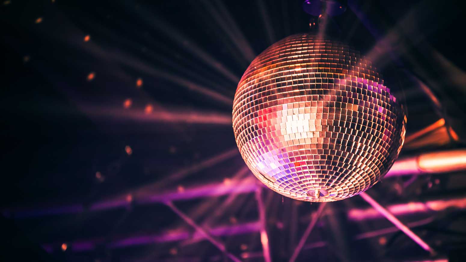 Disco ball with bright rays, night party background photo
