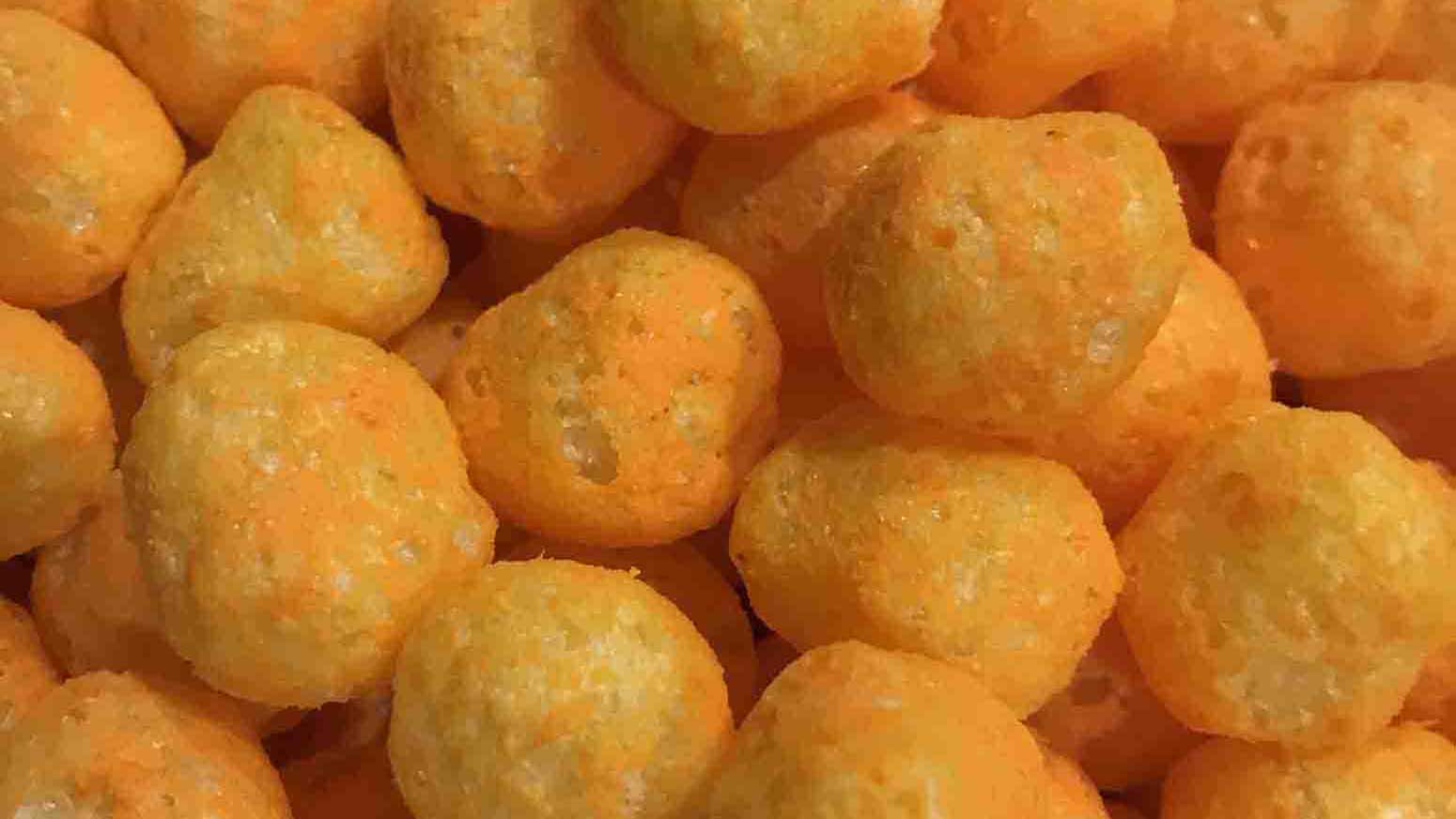 A closeup of bright orange Utz Cheese Balls