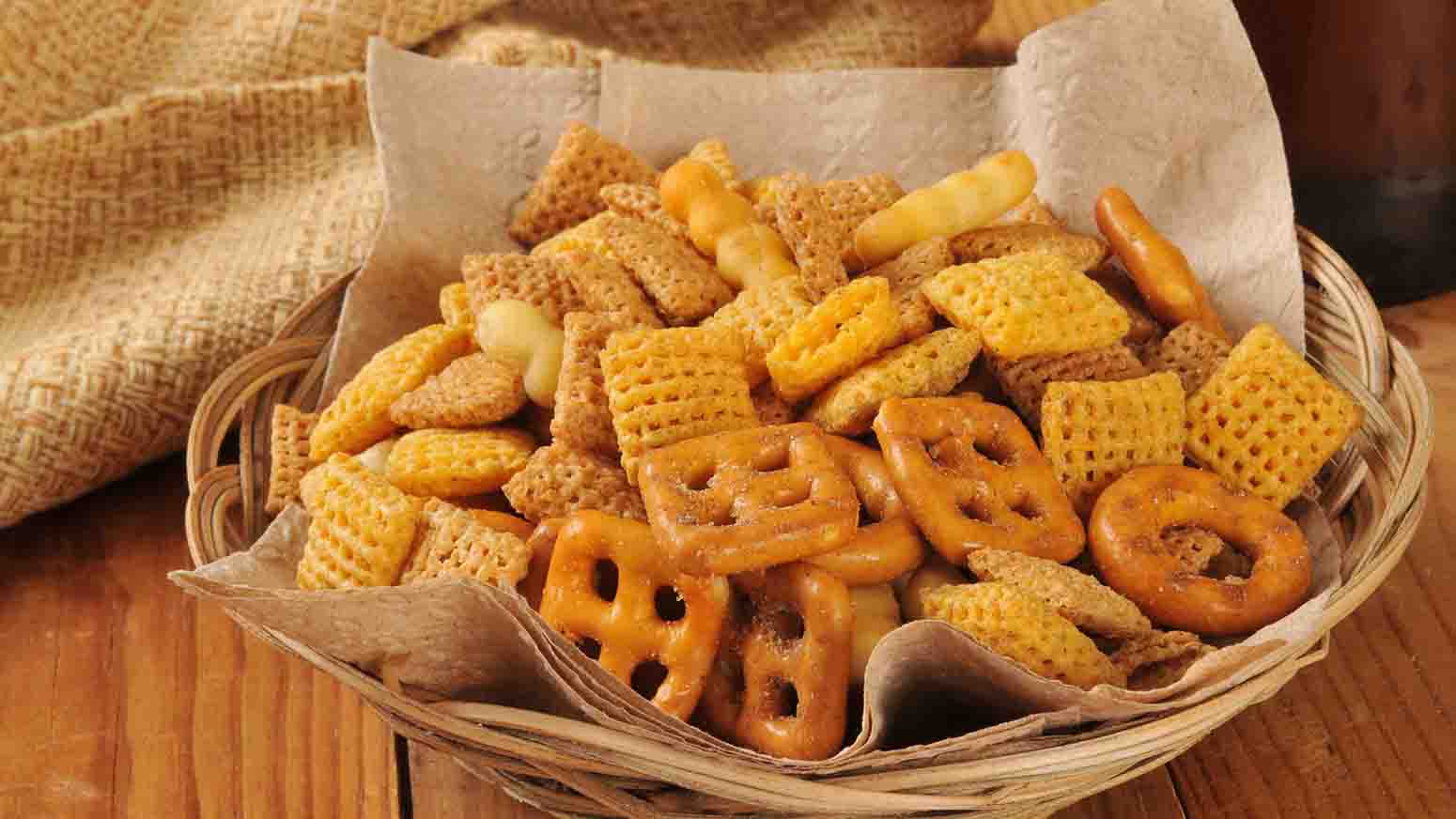 Bar snacks with a bottle of beer on a rustic wooden counter