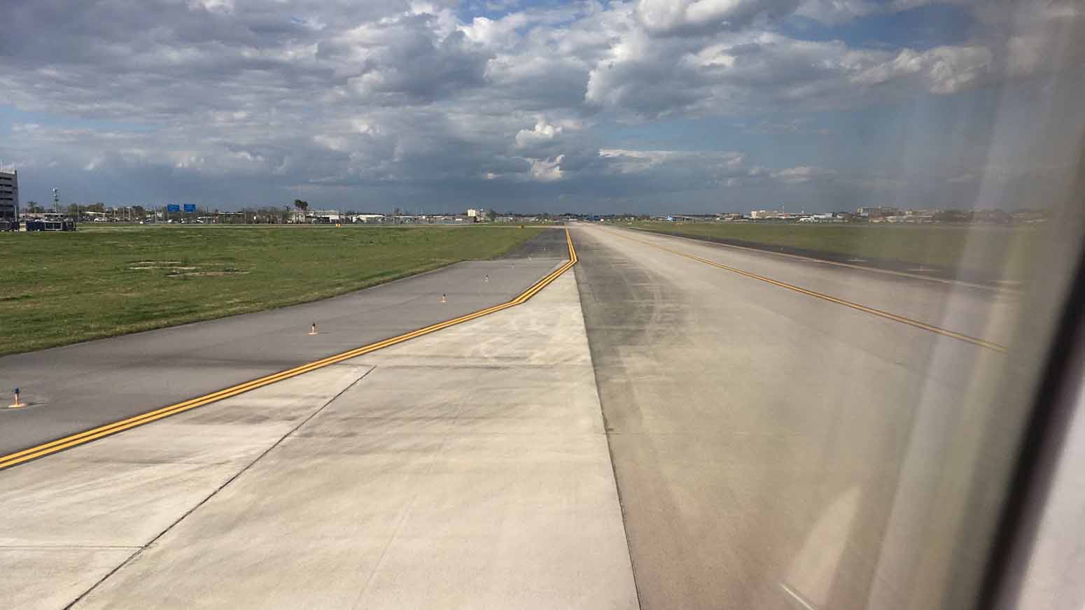 A view of the airstrip and sky from inside the plane