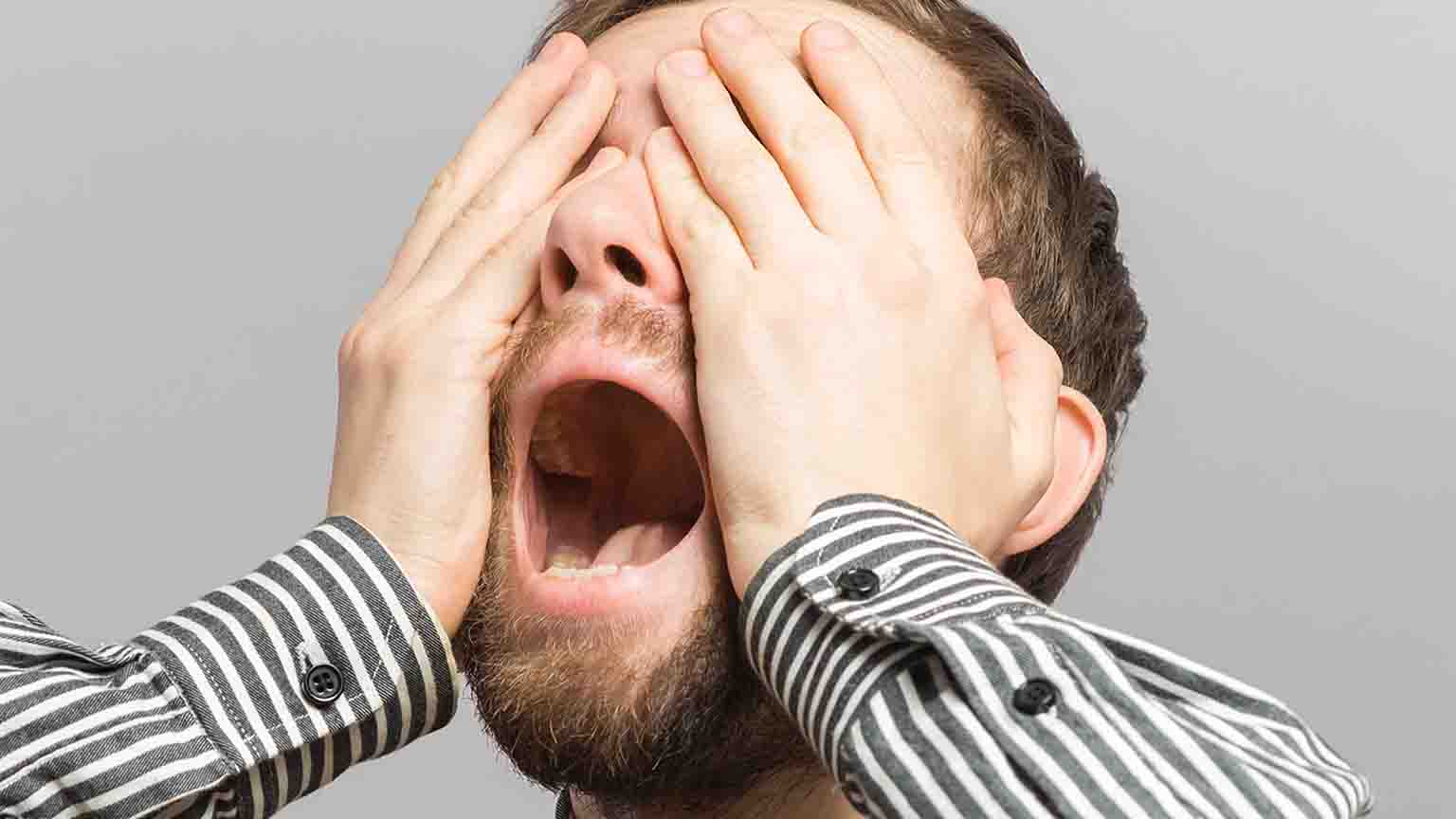 portrait one sad man standing near a wall and covers his face