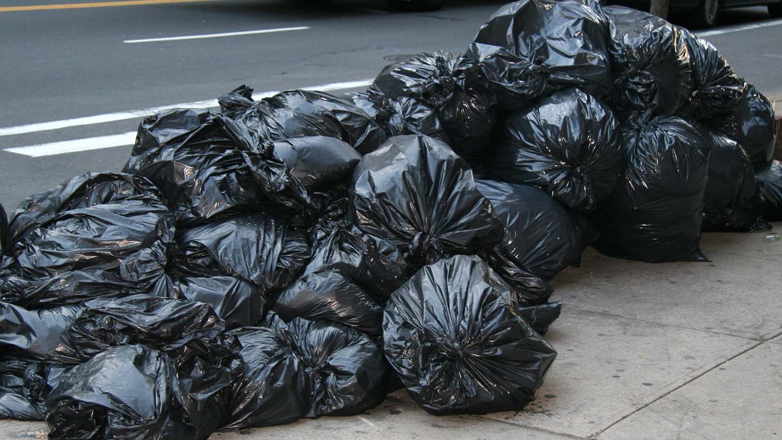 NYC - A pile of garbage bags on a sidewalk