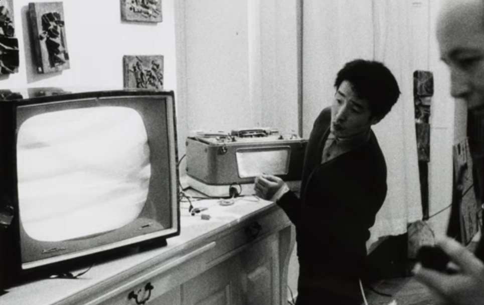 the artist preparing a 60s era TV for exhibition
